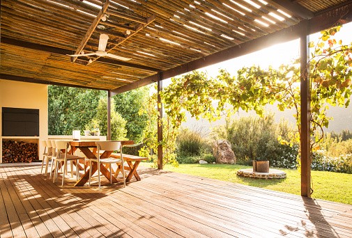 A wooden deck in North Atlanta featuring a table & chairs ideal for outdoor dining and relaxation