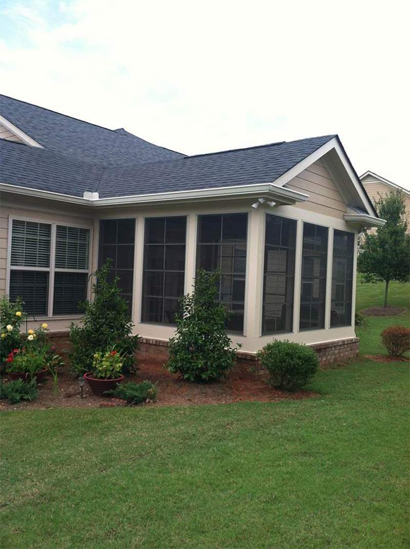 Spacious sunroom with large windows and cozy seating in North Atlanta backyard.