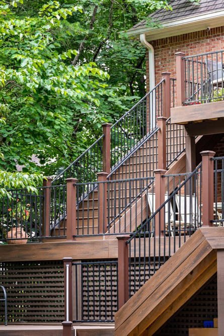 Elegant wooden porch staircase with railing design for a North Atlanta home exterior.