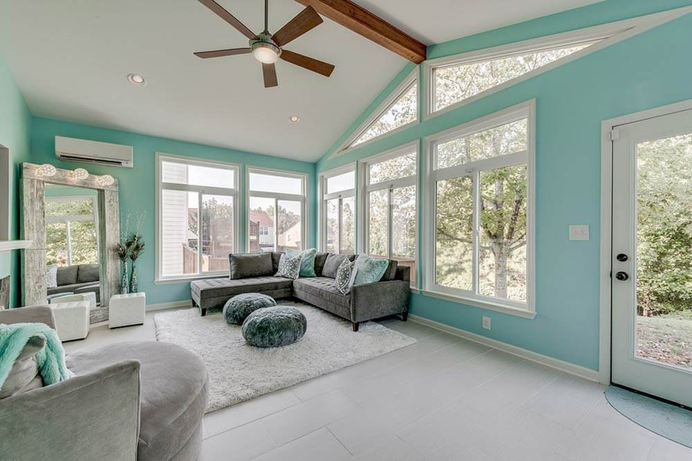 Custom-Built Sunroom in North Atlanta Featuring Blue Walls, White Flooring, and Floor-Length Windows