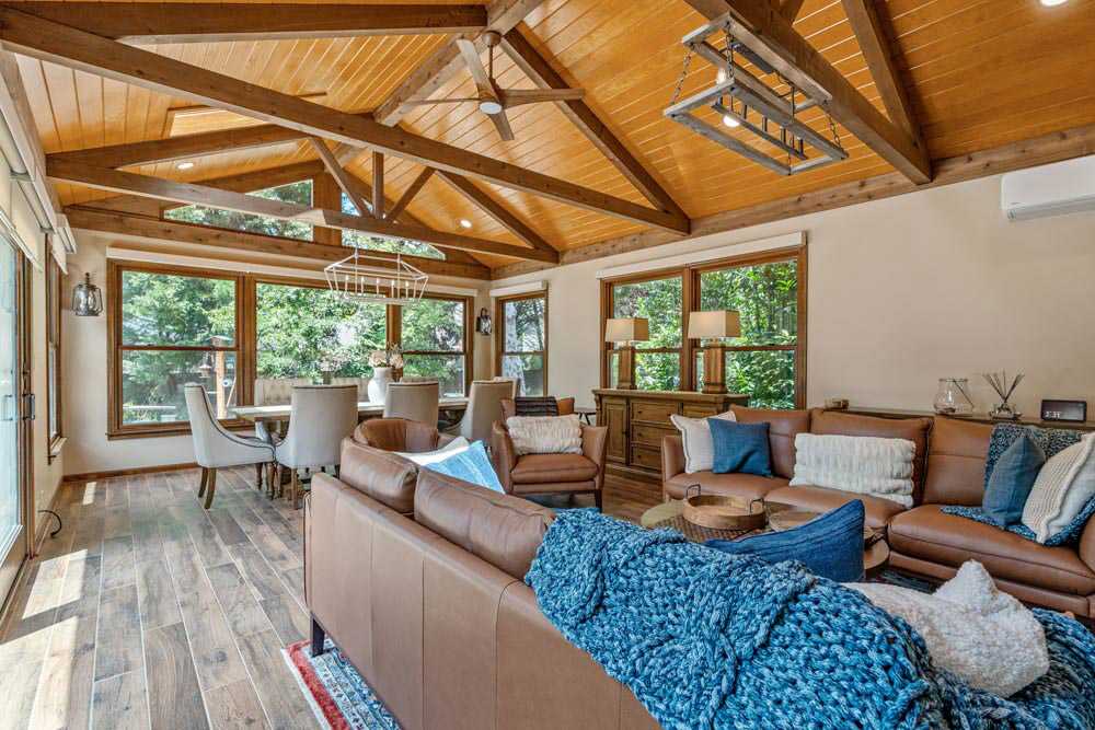 A Sunroom Featuring Wood Beams and Natural Light Streaming Through Large Windows in North Atlanta